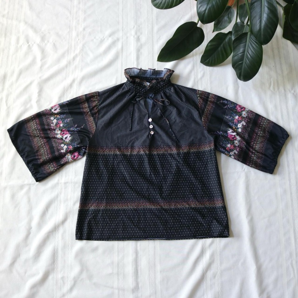 Black polka dot floral blouse with wide sleeves and ruffle neck